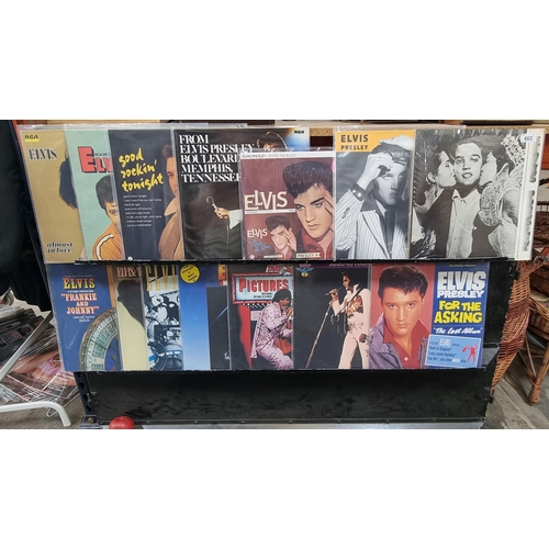 460 - A selection of sixteen vinyl albums featuring the songs of Elvis Presley. Including ''Trouble Bound'... 