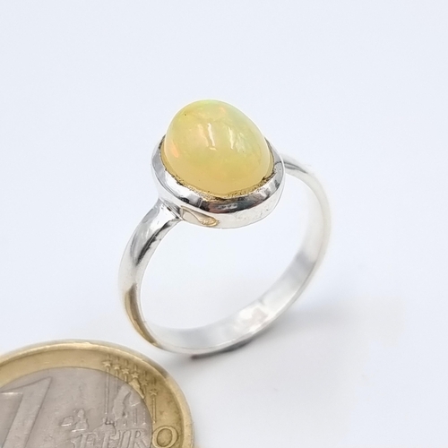 48 - A lovely four carat Australian Fire Opal ring, with lovely colour hue set in sterling silver. Ring s... 
