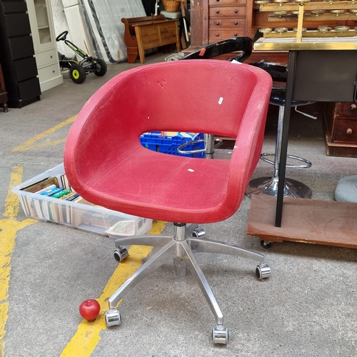 513 - A striking, rise and fall swivel tub chair. On a heavy chrome base and covered in a red upholstery. ... 