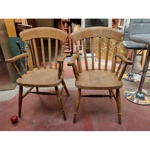 514 - A pair of well made farmhouse carver dining chairs by the company Campsie Pine from Co. Derry in Nor... 