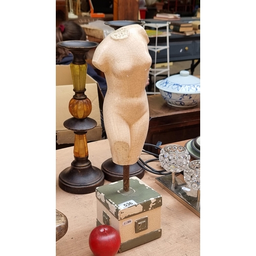 536 - An unusual sculptural piece of a female torso set on a weighted block pedestal secured by a metal po... 