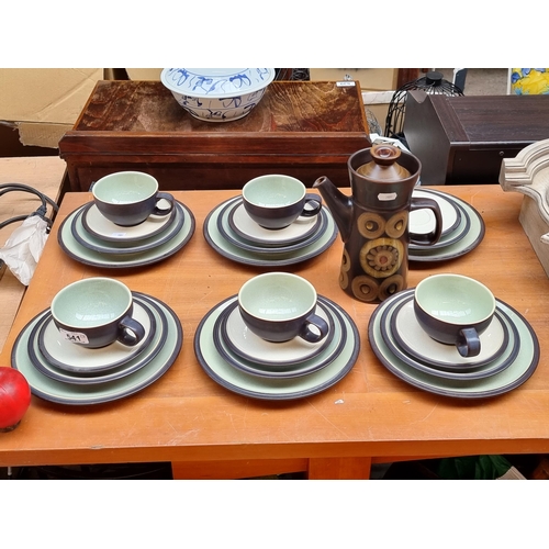 541 - A 24-piece Denby tea service with a charming coffee pot featuring a floral motif in shades of olive ... 