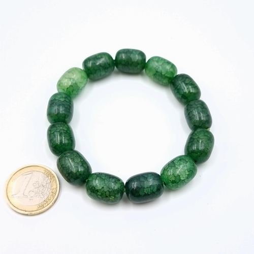 554 - An attractive Green jade barrel beaded stone bracelet. Stones cold to touch.