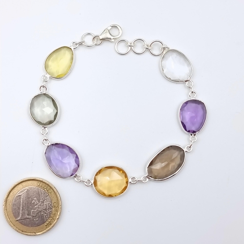 565 - A fabulous Amethyst, Peridot, Citrine, Moonstone and Smokey Quartz sterling silver bracelet. Set wit... 