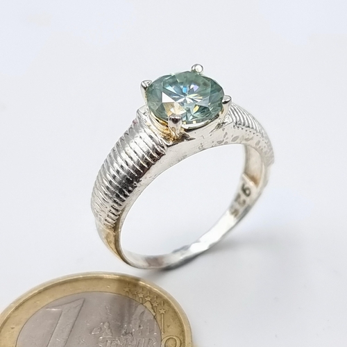 57 - A brilliant cut Ocean Blue Moissanite stone sterling silver ring, of high quality refraction. Ring s... 