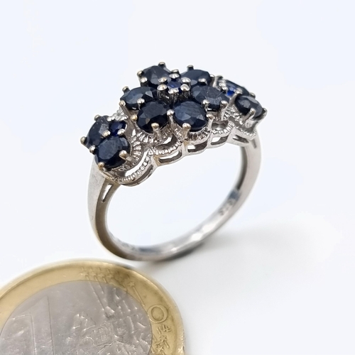 602 - A jaw dropping Sapphire multi stone ring, set with Marcasite detail and forming a fabulous floral mo... 