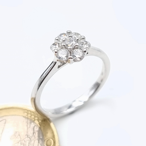 604 - A 9 carat White Gold stamped 375 White Sapphire daisy ring. Ring size: P. Weight: 2.6 grams. Very ni... 