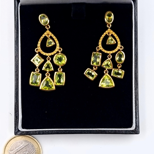 607 - Star Lot : A fine pair of multi stone Peridot drop pendant stud earrings, set in 9 carat gold plated... 