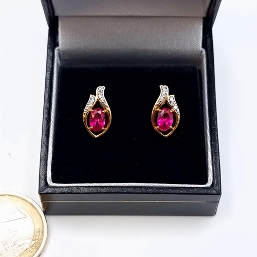 608 - Star Lot : A pair of Ruby stone 9 carat gold plated White Sapphire stud earrings, set with butterfly... 