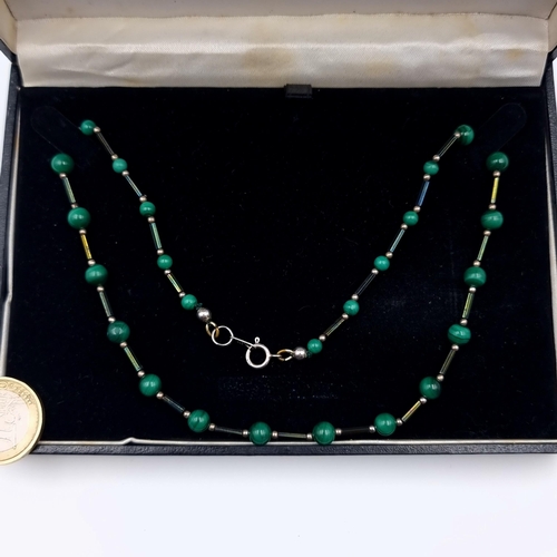7 - An attractive Art Deco necklace, set in sterling silver and featuring a natural Malachite graduated ... 