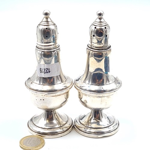 23 - A pair of sterling silver peperettes, these examples feature a bulbous body, graduated base and a pr... 