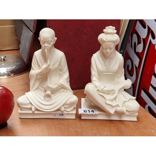 614 - A pair of heavy book ends in the form of traditional Chinese figures. In a cream finish and with the... 