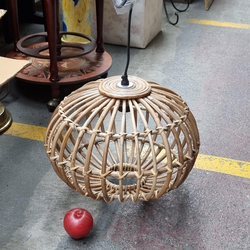 631 - A Qazqa ceiling light fitting with a bent wicker shade. Brand new, never used in original box. Simil... 