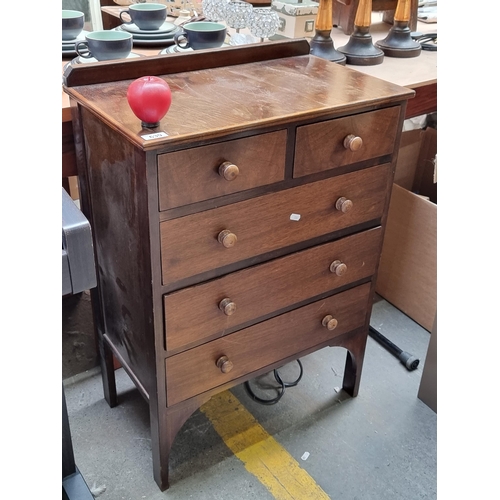 639 - A charming vintage neat size  chest of drawers with five drawers to front, gallery back and held on ... 