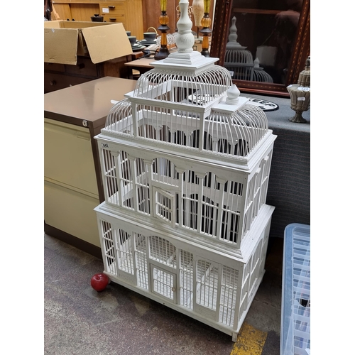 642 - A large spectacular decorative bird cage in the form of a Victorian greenhouse with three tiers, two... 