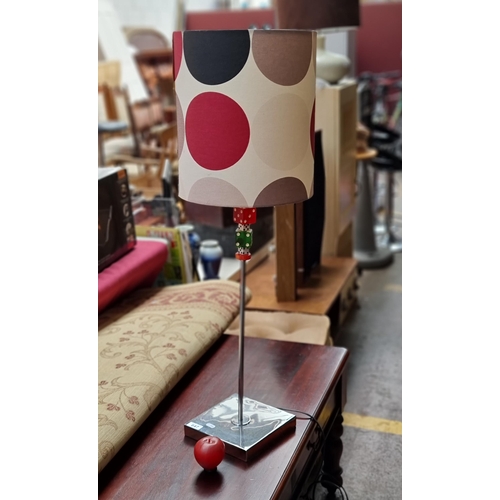 647 - A tall table lamp with a square polished chrome base and a stem boasting a fun colourful dice motif ... 