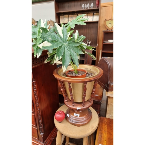 660 - A wooden countertop plant stand with nice turned wood bobbins. Currently holding an artificial potte... 