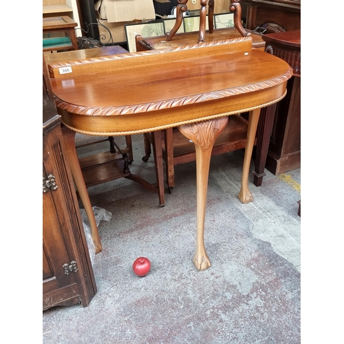 666 - A lovely golden mahogany console table with rounded edge boasting rope twist carving to apron, galle... 