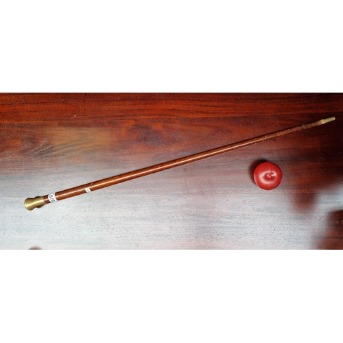 670 - A lovely heavy vintage wooden walking stick with brass tip and knob handle embedded with an Irish co... 