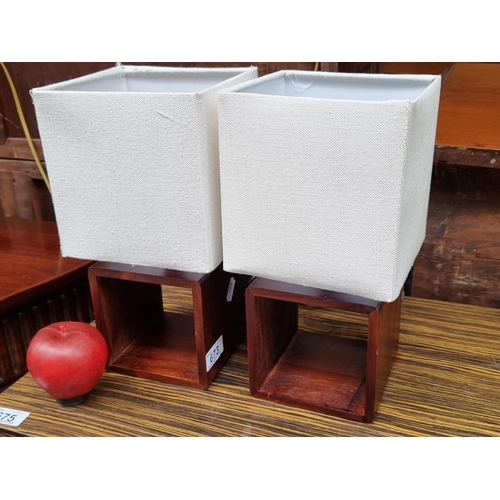 673 - A very chic pair of matching bedside table lamps featuring nice square wooden bases with rounded cor... 