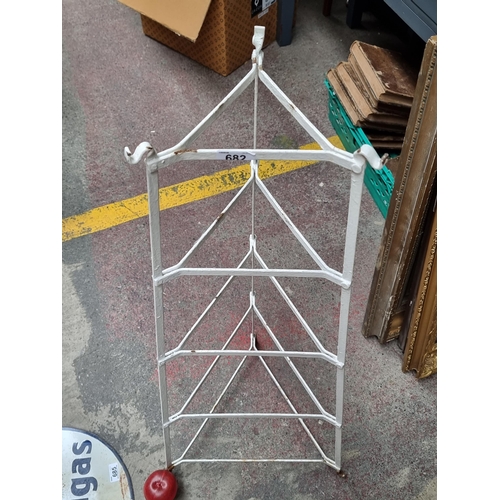 682 - A very nice pyramid shaped pot stand, with wrought metal detailing and a painted white finish.