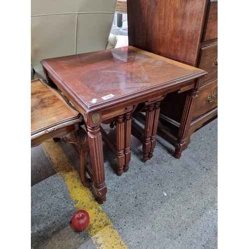 710 - A fantastic set of nesting tables including one large example with slots to base to hold two further... 