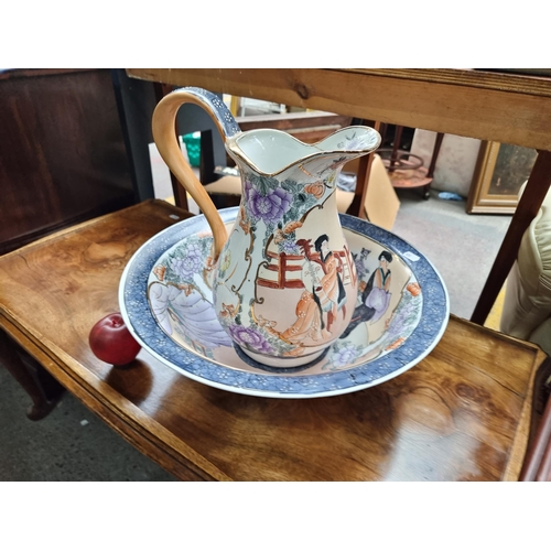 711 - A gorgeous Japanese style ceramic pitcher and wash basin decorated with hand painted courting scenes... 