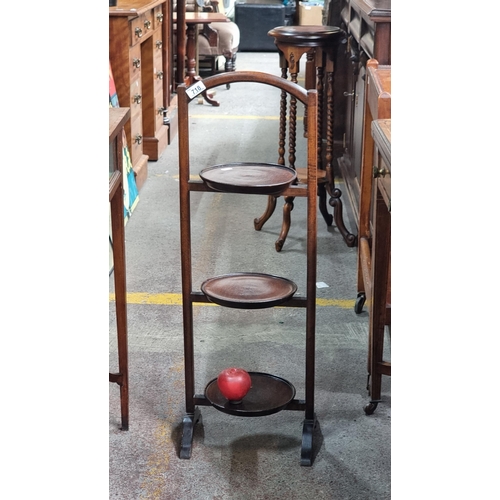 718 - A lovely wooden 1930s folding cake stand with three tiers.