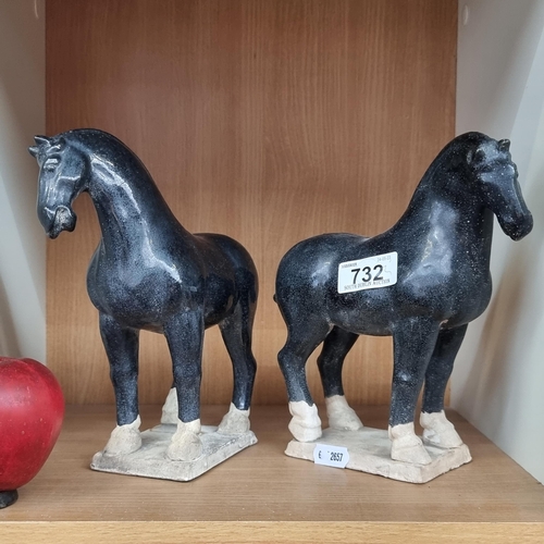 732 - A pair of ceramic horse figures featuring attractive crazing and a navy finish. Stood on square pede... 