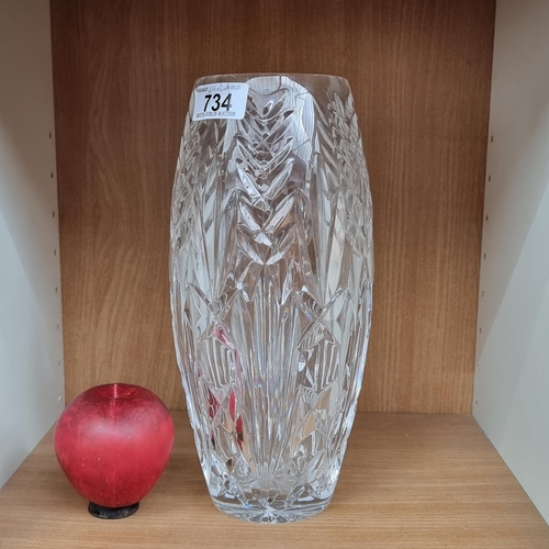 734 - A beautiful tall Waterford Crystal vase boasting an intricate foliate design. With acid mark to base... 