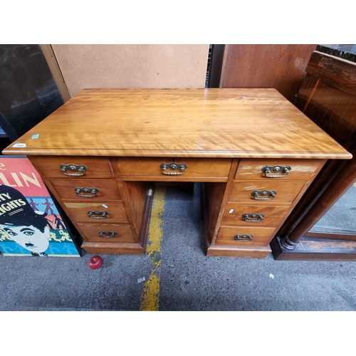 745 - A well made vintage desk with nine drawers featuring brass drop handles with turned detailing. Lovel... 