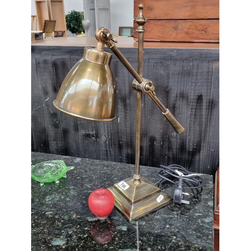 748 - An elegant heavy quality table lamp with an articulated stem and shade. In an attractive brushed bra... 