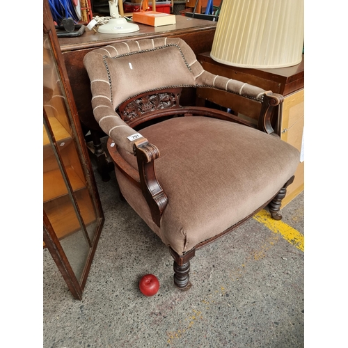 751 - Star Lot : A beautiful Victorian mahogany tub chair with open backrest featuring and intricately car... 