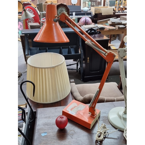 756 - A striking Mid Century desk lamp with an articulated stem and weighted base. In a brilliant orange s... 