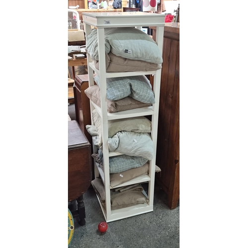 759 - A free standing five tier open shelving unit. Accompanied by a collection of ten high quality scatte... 