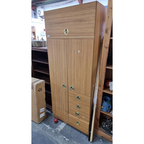 765 - A fabulous mid century  wardrobe with a super retro aesthetic. Featuring a myriad of storage compart... 