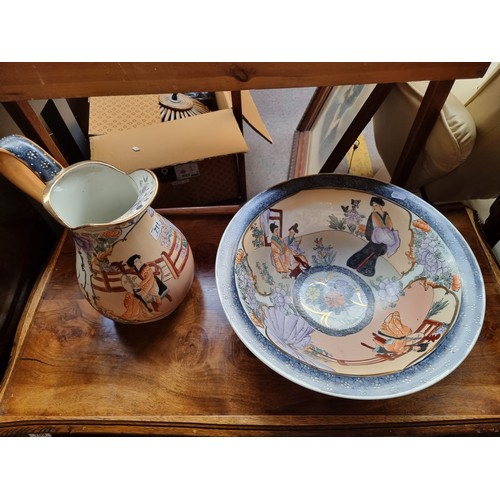 711 - A gorgeous Japanese style ceramic pitcher and wash basin decorated with hand painted courting scenes... 