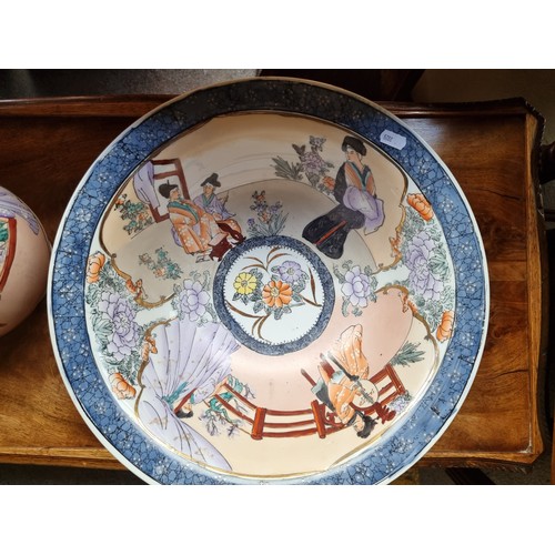 711 - A gorgeous Japanese style ceramic pitcher and wash basin decorated with hand painted courting scenes... 