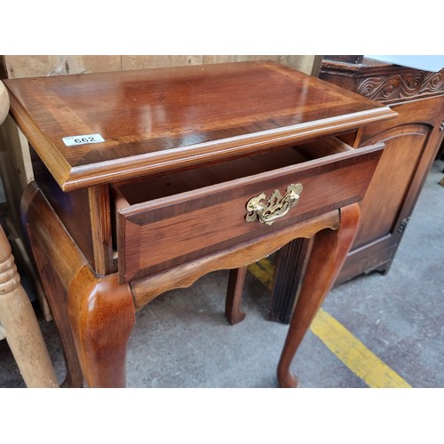 662 - A lovely golden mahogany side table with single drawer to front boasting brass drop handle. Held on ... 