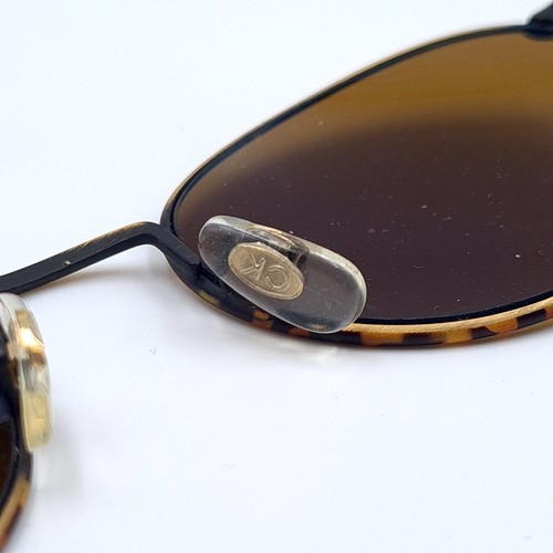 6 - A pair of genuine vintage Calvin Klein sunglasses, these great looking examples featuring faux torto... 