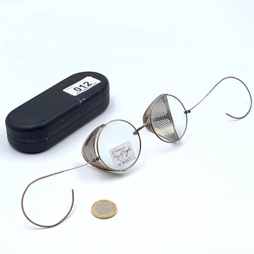 12 - An interesting pair of vintage wire rimmed steam punk glasses, set with adjustable safety covers. It... 