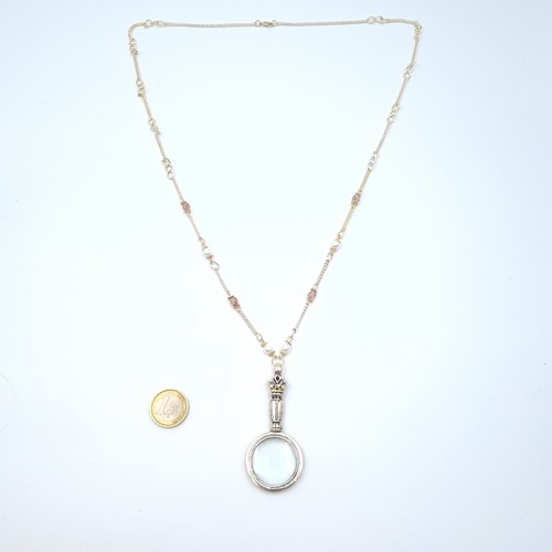 19 - A vintage style pedant necklace, set with magnifying glass pendant and featuring a jewelled handle. ... 