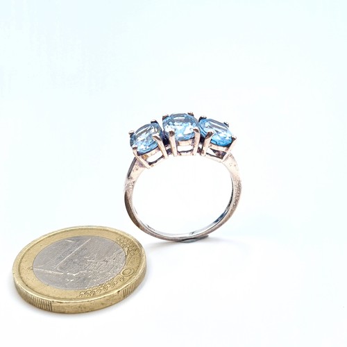 38 - A show stopping sterling silver three stone blue gem stone ring. Ring size: P. Weight: 3.29 grams.