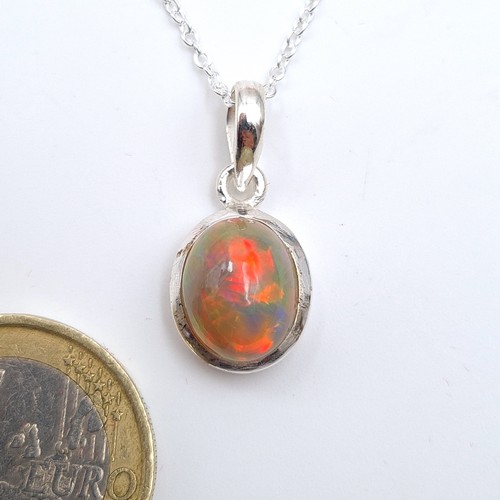 59 - A stunning oval cut Australian fire opal in a sterling silver setting with chain. Length 25cm. New f... 