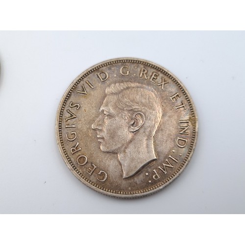 569 - Two items, including a 1943 Canadian silver one dollar, of 0.8000 fineness. Weight: 23.32 grams. Tog... 