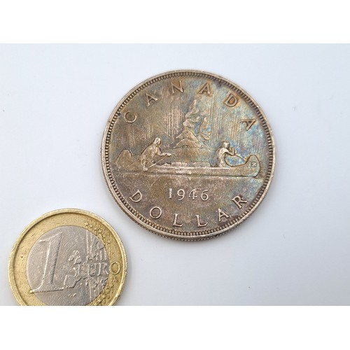 569 - Two items, including a 1943 Canadian silver one dollar, of 0.8000 fineness. Weight: 23.32 grams. Tog... 