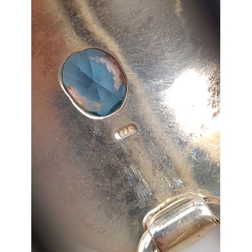 576 - A striking sterling silver abstracted Aquamarine stone mounted two bar bangle. Set with mounted clas... 