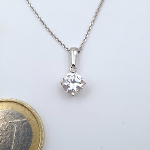 581 - Star Lot : A sparkling 9 carat White Gold Zircon stone necklace, a nice clean example which is stamp... 