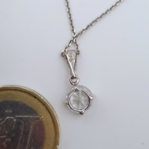 581 - Star Lot : A sparkling 9 carat White Gold Zircon stone necklace, a nice clean example which is stamp... 