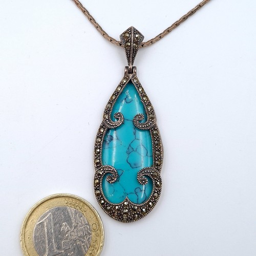 582 - A Bohemian style tear drop pendant necklace, set with a large central Turquoise stone and a Marcasit... 